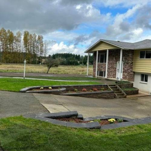 Backyard hardscape design with pavers and custom seating area